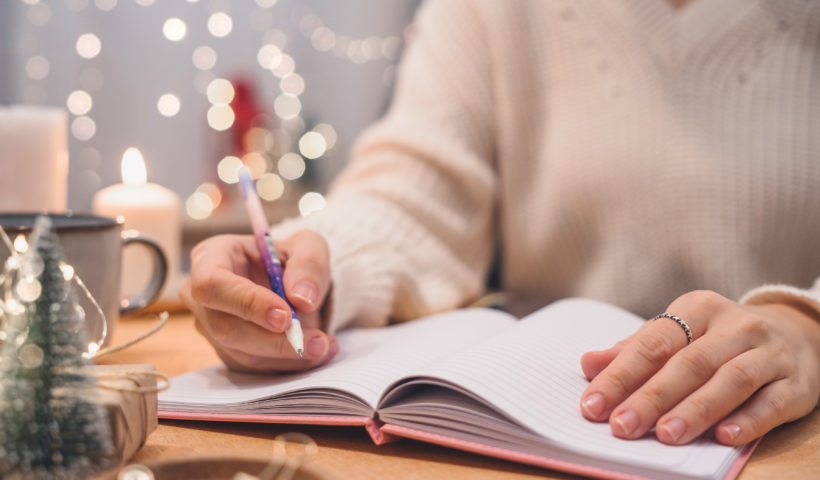 Woman making holiday lists organize and declutter before the holidays Shutterstock Those Someday Goals