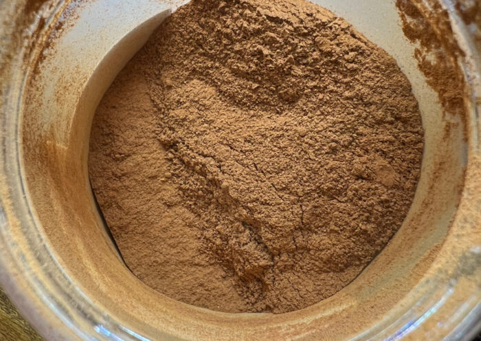 Close-up on ground cinnamon powder in a clear jar on a wood table cinnamon recall spice Those Someday Goals