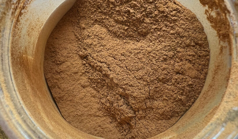 Close-up on ground cinnamon powder in a clear jar on a wood table cinnamon recall spice Those Someday Goals