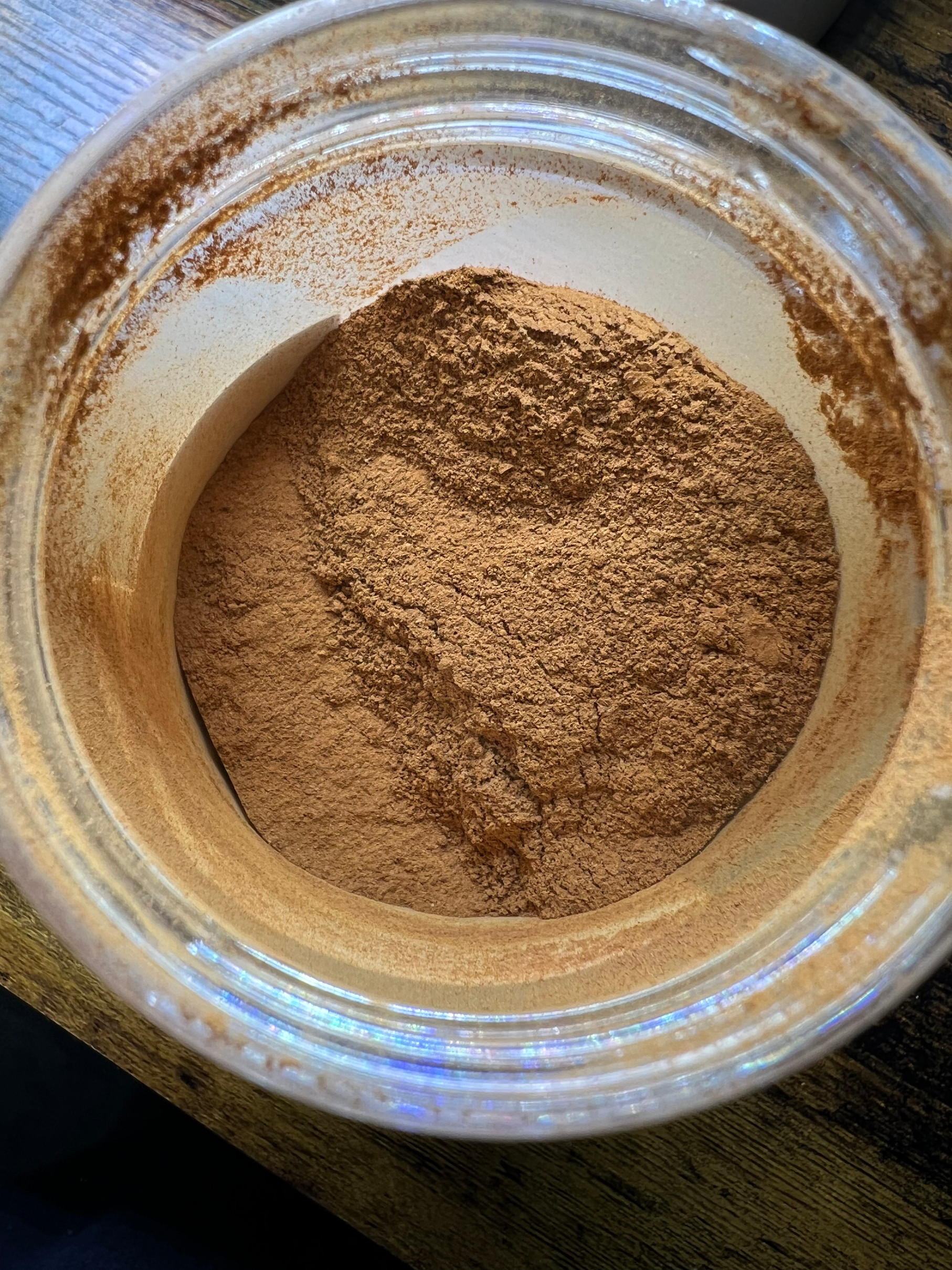 Close-up on ground cinnamon powder in a clear jar on a wood table cinnamon recall spice Those Someday Goals