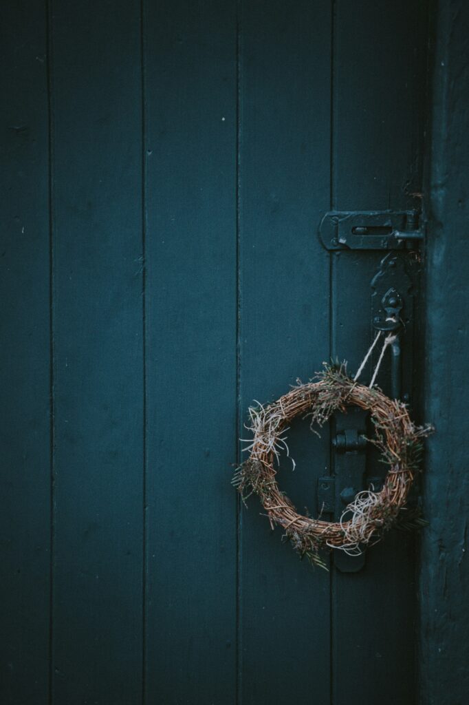 Twigs around a small wire frame on a black door latch