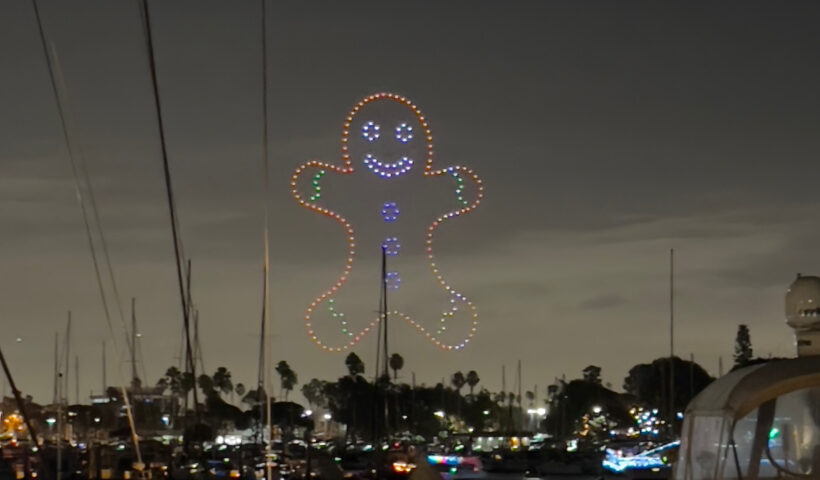 gingerbread drone lights over marina boat parade holiday lights Christmas decorations