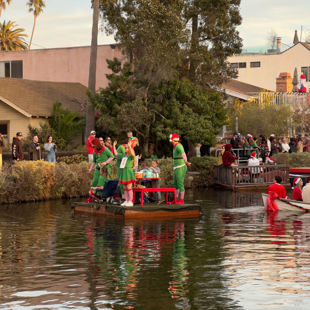 Elves giving gifts during the boat parade Venice Canal Boat Parade Christmas Decorations Holiday Decorations California Celebration