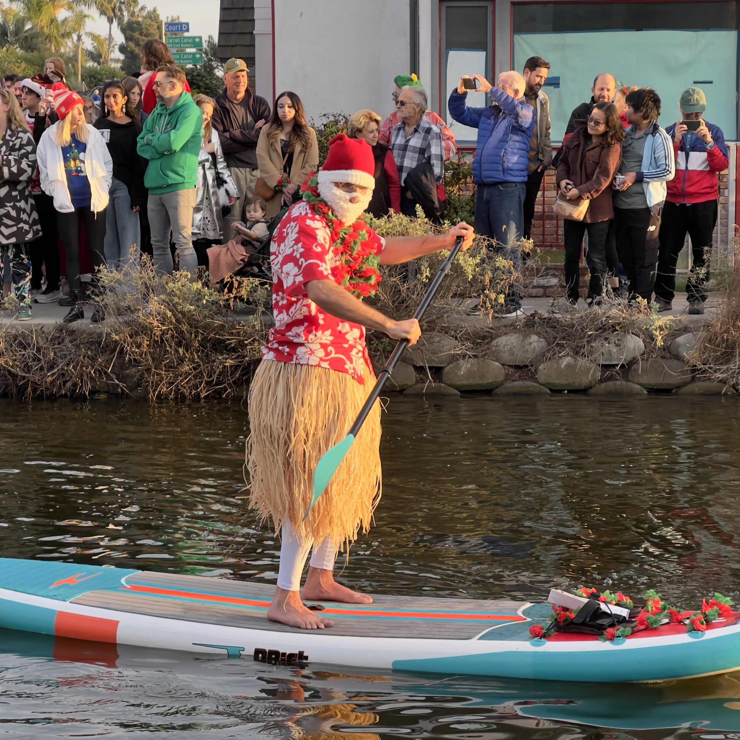 Santa on a paddle board Venice Canal Boat Parade Christmas Decorations Holiday Decorations California Celebration