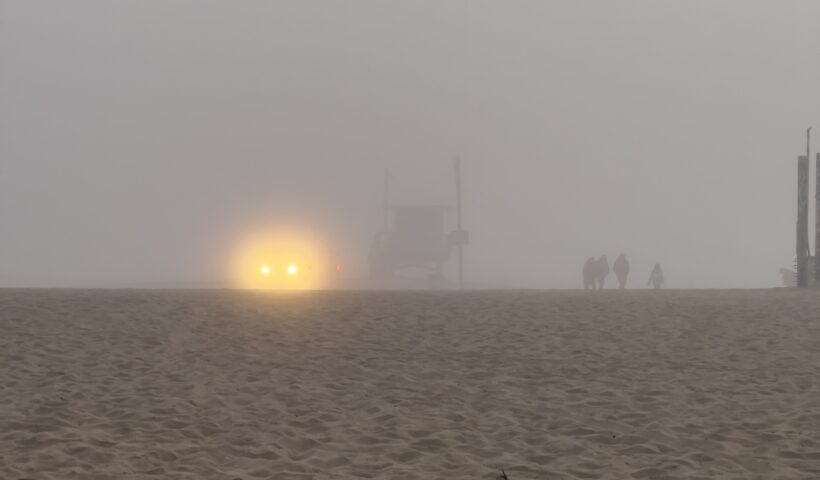 Beach in Fog headlights winter lifeguard shack people walking on sand decluttering emergency kits