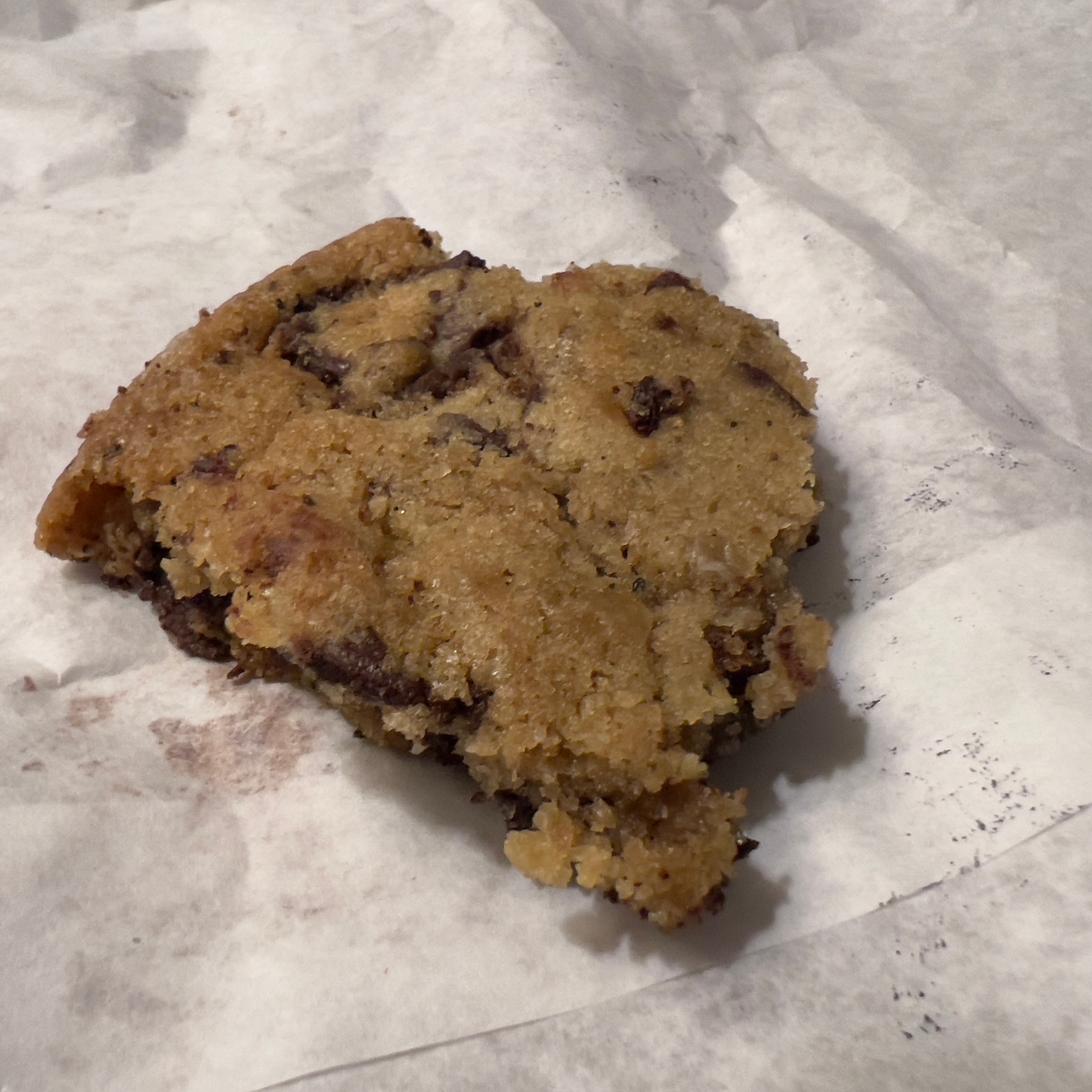 Salted chocolate chip cookie piece on a white paper bag Those Someday Goals cookies for January